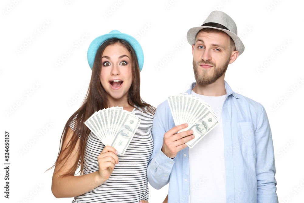 Happy young couple in straw hats with dollar banknotes on white background Happy young couple in straw hats with dollar banknotes on white background
