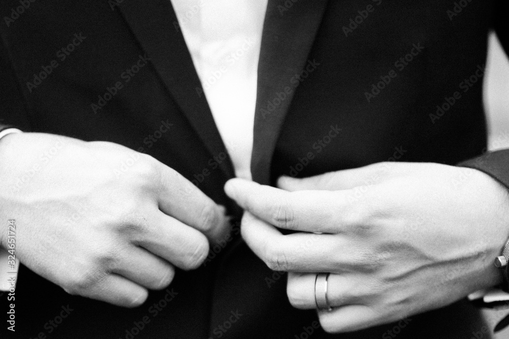 black and white. Groom hands