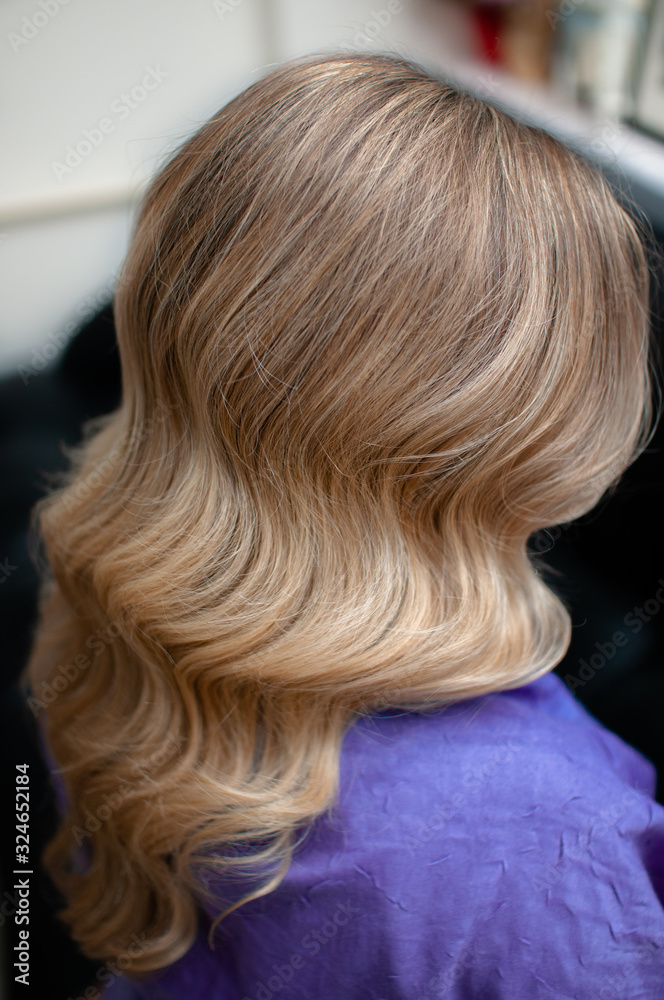 Blond woman with hairstyle of long wavy hair Blond woman with hairstyle of long wavy hair