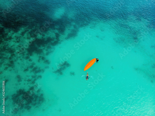 Man and a woman with a kayak in the sea with clear turquoise water. Kayaking, leisure activities on the ocean © dpVUE .images