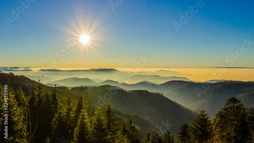 Amazing panorama background banner from a fog landscape with sunset  in the evening in black forest photo