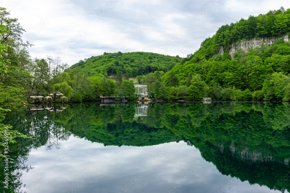 Deep-water mountain lake with crystal clear water and mountain landscape.