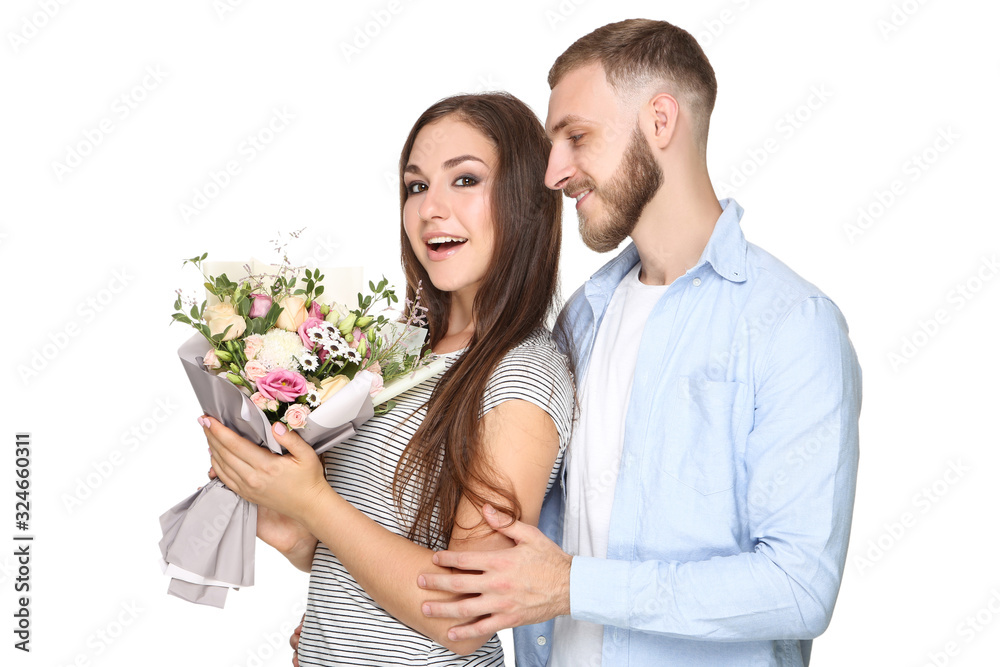 Happy young couple with bouquet of flowers on white background Happy young couple with bouquet of flowers on white background