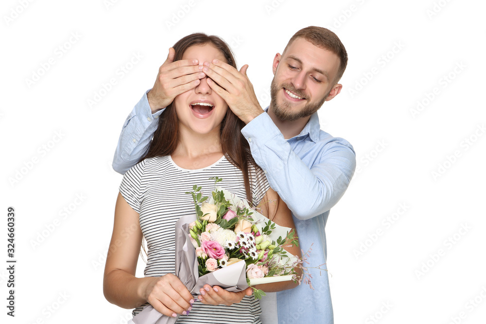 Happy young couple with bouquet of flowers on white background Happy young couple with bouquet of flowers on white background