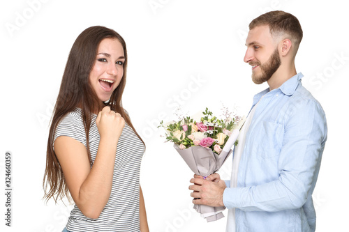 Happy young couple with bouquet of flowers on white background © 5second