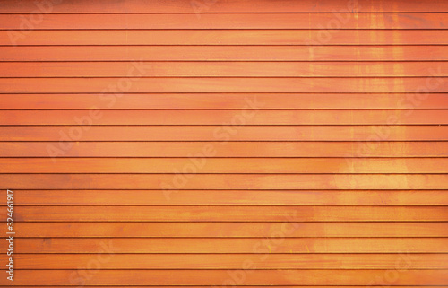 The wall of the wooden house is painted yellow and orange