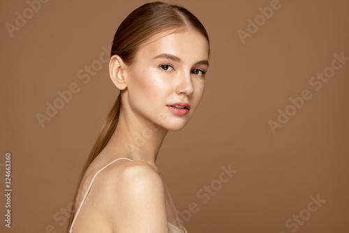 Face skin care. Beautiful young woman with perfect skin posing against background. Beauty treatment and spa concept. photo