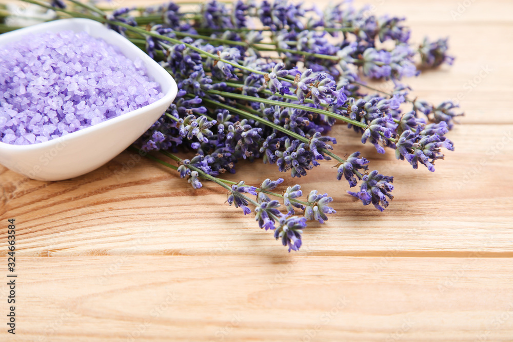 Lavender flowers and spa salt on brown wooden table Lavender flowers and spa salt on brown wooden table