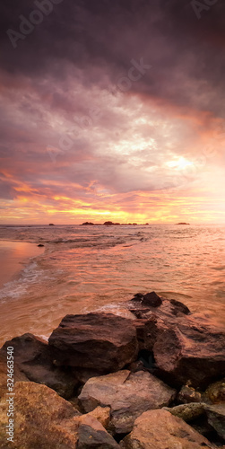 Beautiful landscape of sun setting down over the ocean and sharp cliffs