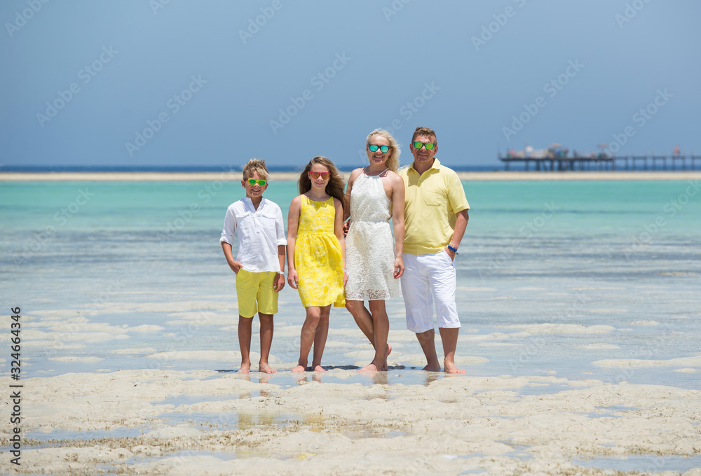 Happy family at the tropical beach during summer vacation . Sun, sand and sea. Happy family at the tropical beach during summer vacation . Sun, sand and sea.
