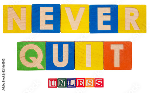 Foto Inspirational NEVER QUIT concept spelled out in colorful toy blocks with caveat UNLESS qualifier