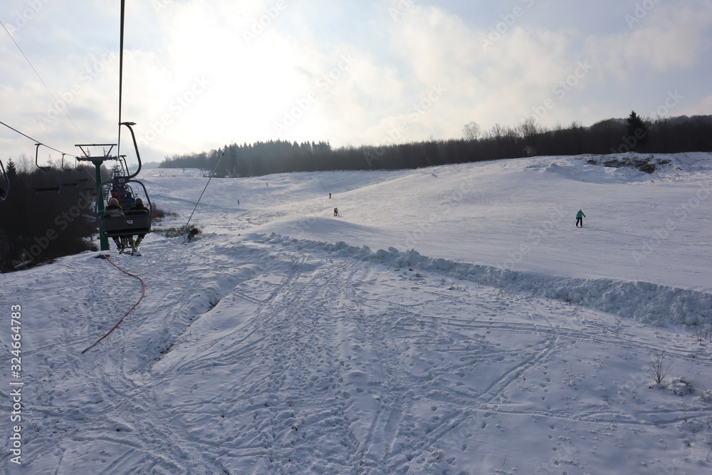 Fototapeta premium people enjoy outdoor activities in the mountains, skiing and snowboarding