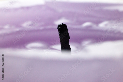 wax drops of a candle of lilac color photo