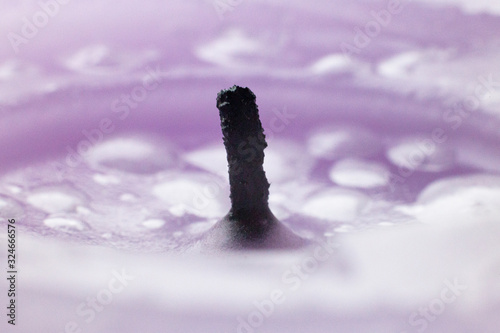 wax drops of a candle of lilac color photo