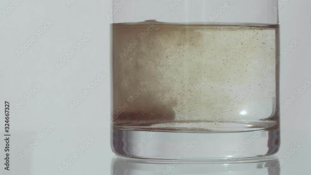 Effervescent vitamin tablet dissolving in glass of water. 4K resolution. High quality audio recorded with condenser microphone.