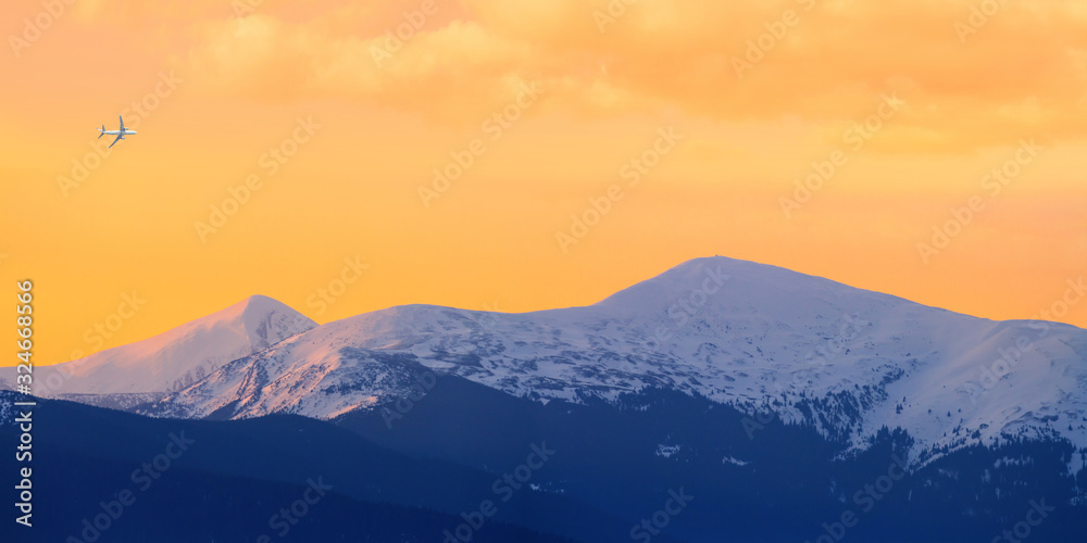 Winter landscape at sunrise, panorama, banner - view of the mountain range the Chornohora with the mountains Hoverla and Petros, Carpathian mountains in Ukraine