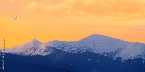 Winter landscape at sunrise, panorama, banner - view of the mountain range the Chornohora with the mountains Hoverla and Petros, Carpathian mountains in Ukraine