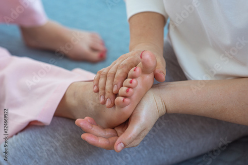 Hand making thai feet massage. Alternative medicine and thai massage concept 
