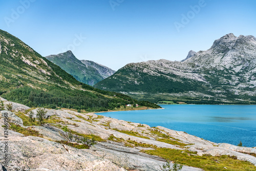 View at calm bay in Norway, between Nesna and Maela villages, blue water of Atlantic ocean, mountains, Calm sunny summer day Norway