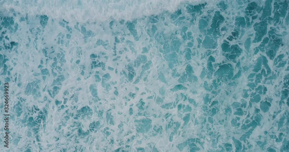 Aerial view of turbulent ocean white water and waves background, extreme weather patterns and ocean swells, ocean background