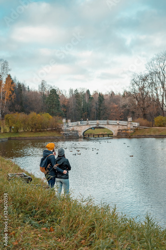 Postcard: loving couple looking at landscape in the autumn Pavlovsk park.
