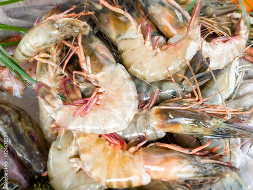 Closeup photo of fresh uncooked prawn on the counter at seafood restaurant