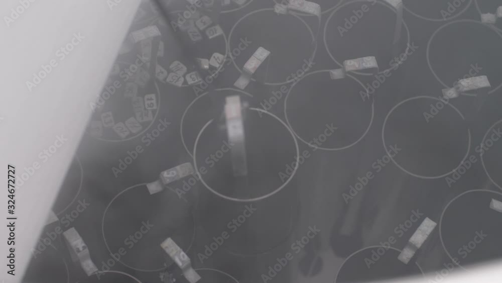 Close-up of placing frozen embryos inside cryobank for subsequent storage and later use during in vitro fertilization or intracytoplasmic sperm injection, cryotechnologies in reproductive medicine