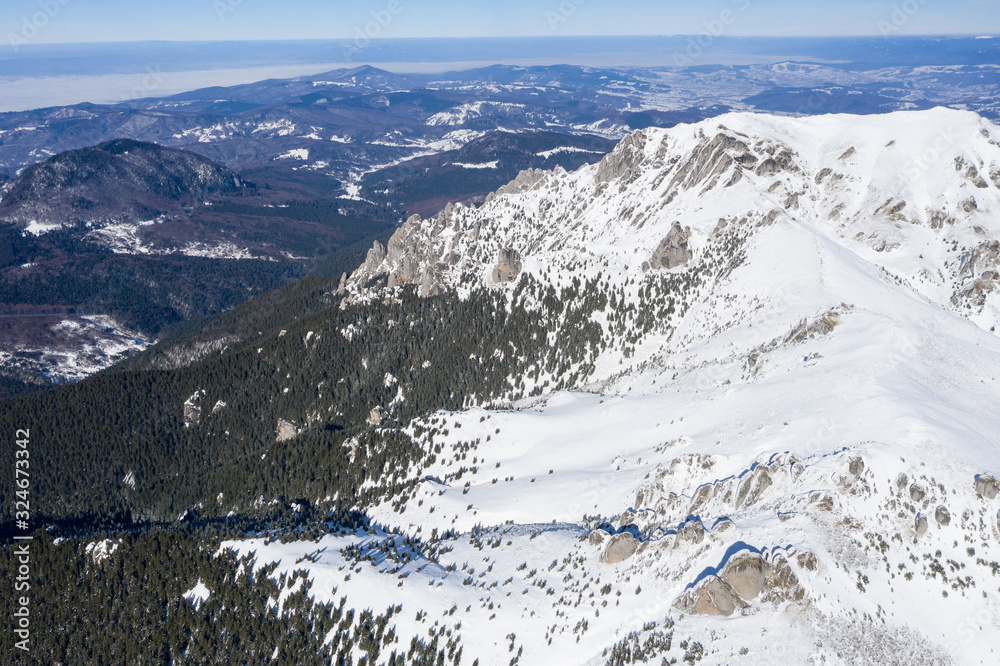 Aerial drone panorama of Ciucas Mountains in winter season.