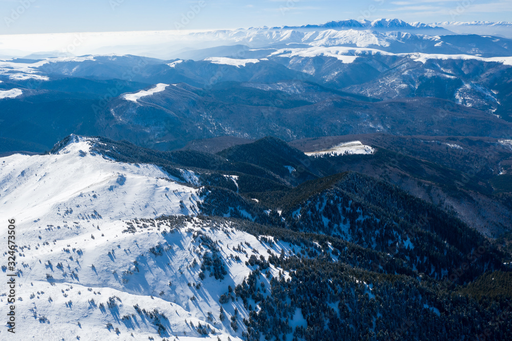 Aerial drone panorama of Ciucas Mountains in winter season.