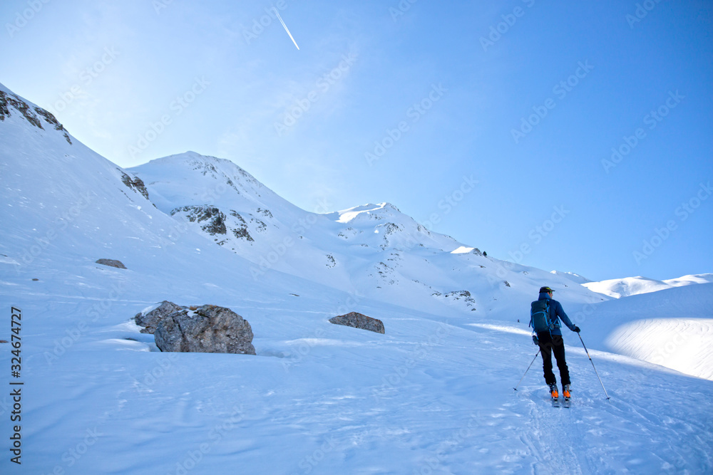 man making touring ski in a sunny day surrounded of mountains in Pyrenees man making touring ski in a sunny day surrounded of mountains in Pyrenees