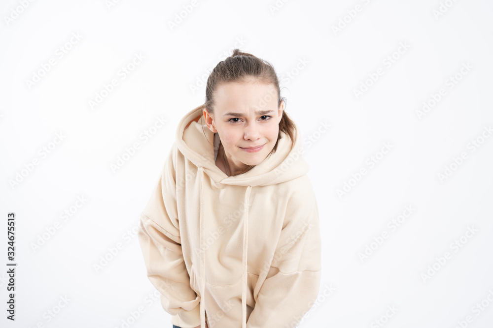 Image of pleasant looking self assured woman with serious expression, listens information attentively, dressed in hoodie, isolated over white background Image of pleasant looking self assured woman with serious expression, listens information attentively, dressed in hoodie, isolated over white background
