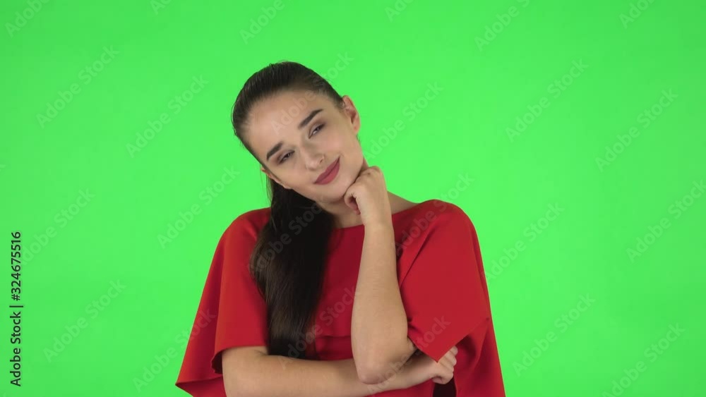 Portrait of pretty young woman is daydreaming and smiling looking up. Green screen Portrait of pretty young woman is daydreaming and smiling looking up. Green screen