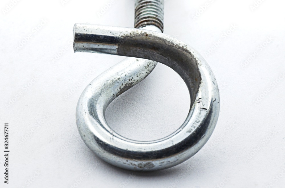 Steel pigtail screw hook on white background. Safety piece of hardware.