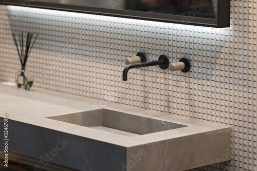 Bathroom interior grey marble sink and black tap. Beautiful modern bathroom design