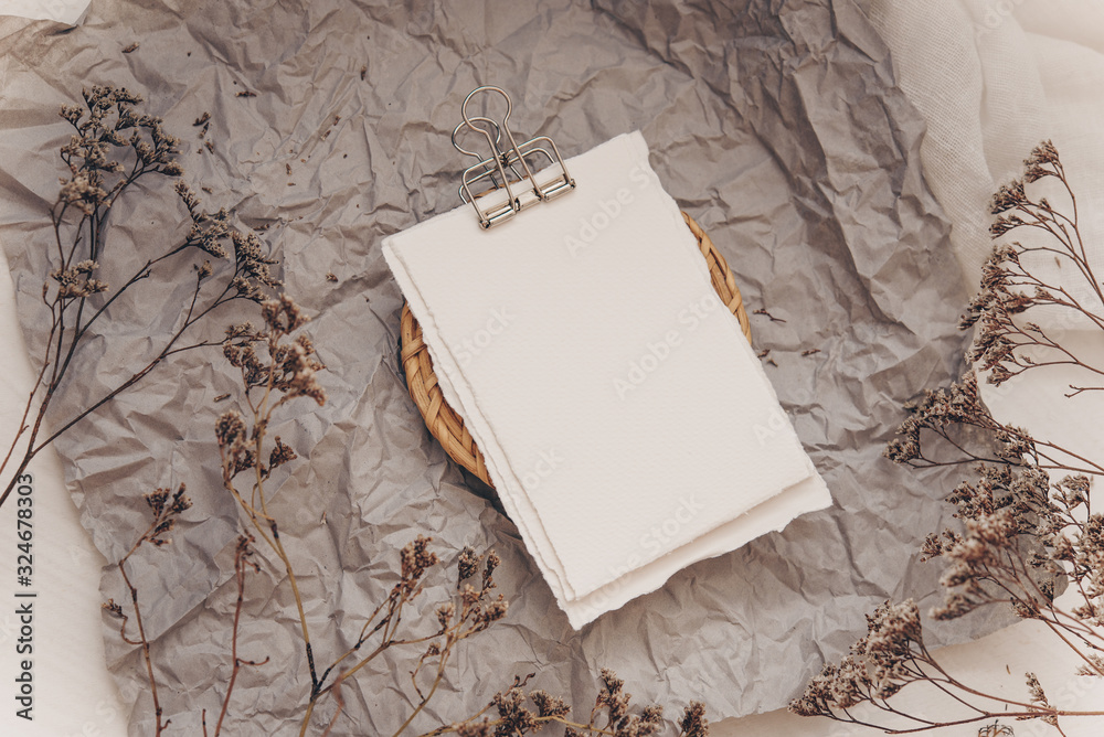 Wedding invitation mockup with dry plants , papers on white textile background. Top view, flat lay. Wedding stationary. Perfect for presentation of your invitation, menu, greeting cards Wedding invitation mockup with dry plants , papers on white textile background. Top view, flat lay. Wedding stationary. Perfect for presentation of your invitation, menu, greeting cards
