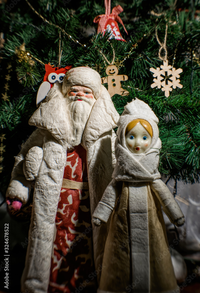 Christmas card in retro style. Old-fashioned figurine of St. Nicholas on the background of the Christmas tree