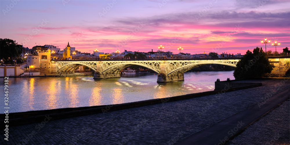 Fototapeta premium View Of Triana Bridge In Seville Spain At Sunset