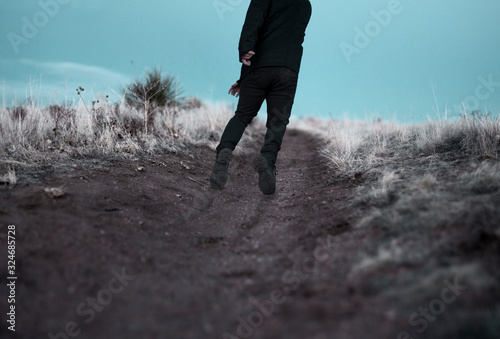 Obraz na plátně Man being dragged through desert landscape by unseen force