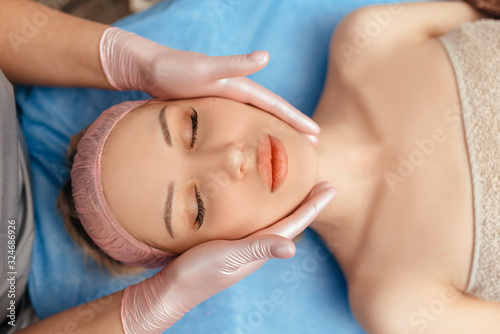 face massage on woman in the spa salon