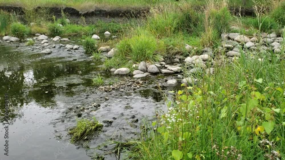 shot of water flowing through Sturgeon Creek in September in Winnipeg, Manitoba. shot of water flowing through Sturgeon Creek in September in Winnipeg, Manitoba.