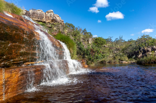 Sentinela waterfall with small lake and trees around, blue sky, Diamantina, Minas Gerais, Brazil