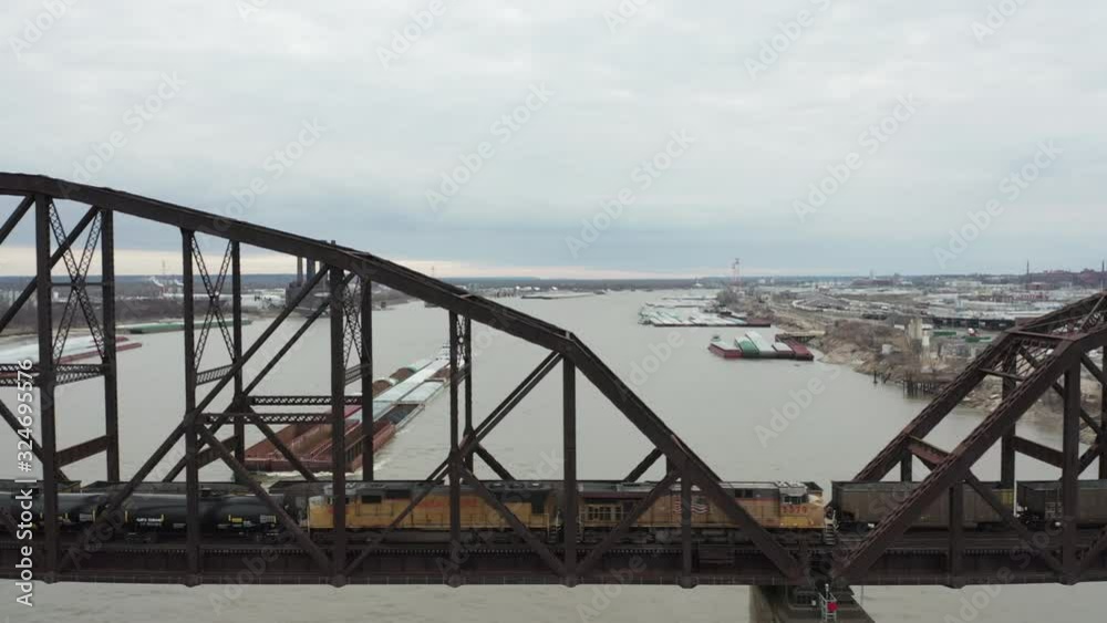 Tracking shot along train bridge over Mississippi River. Train parked on bridge. Tracking shot along train bridge over Mississippi River. Train parked on bridge.