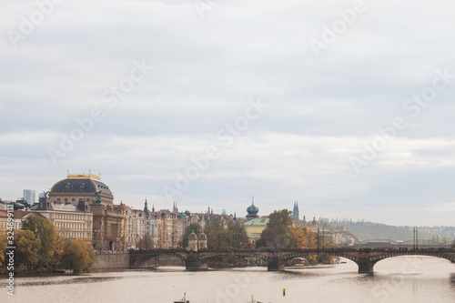 Panorama of Prague, Czech Republic, seen from the Vltava river, also called Moldau, with a focus on Most Legii, or Legion Most, one of the landmarks of the city, during a cloudy sunset in autumn