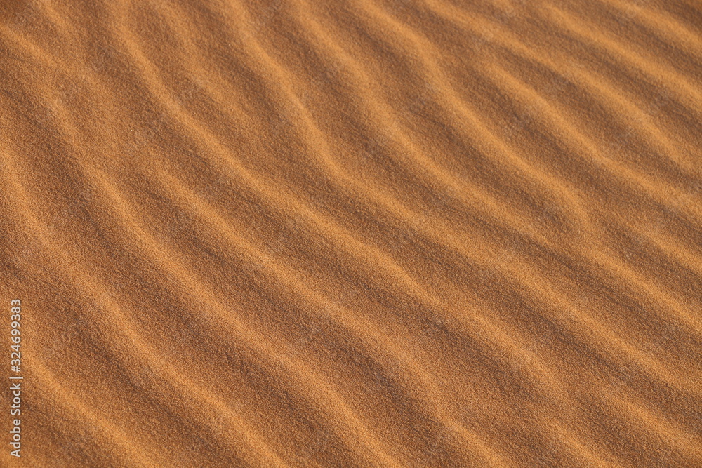 sand texture - background of desert sand dunes. Beautiful structures of sandy dunes. sand with wave from wind in desert - Close up sand texture - background of desert sand dunes. Beautiful structures of sandy dunes. sand with wave from wind in desert - Close up
