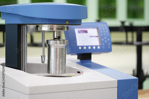 Calorimeter is measuring that can be used to determine heat of reaction of a liquid or solid fuel sample. photo