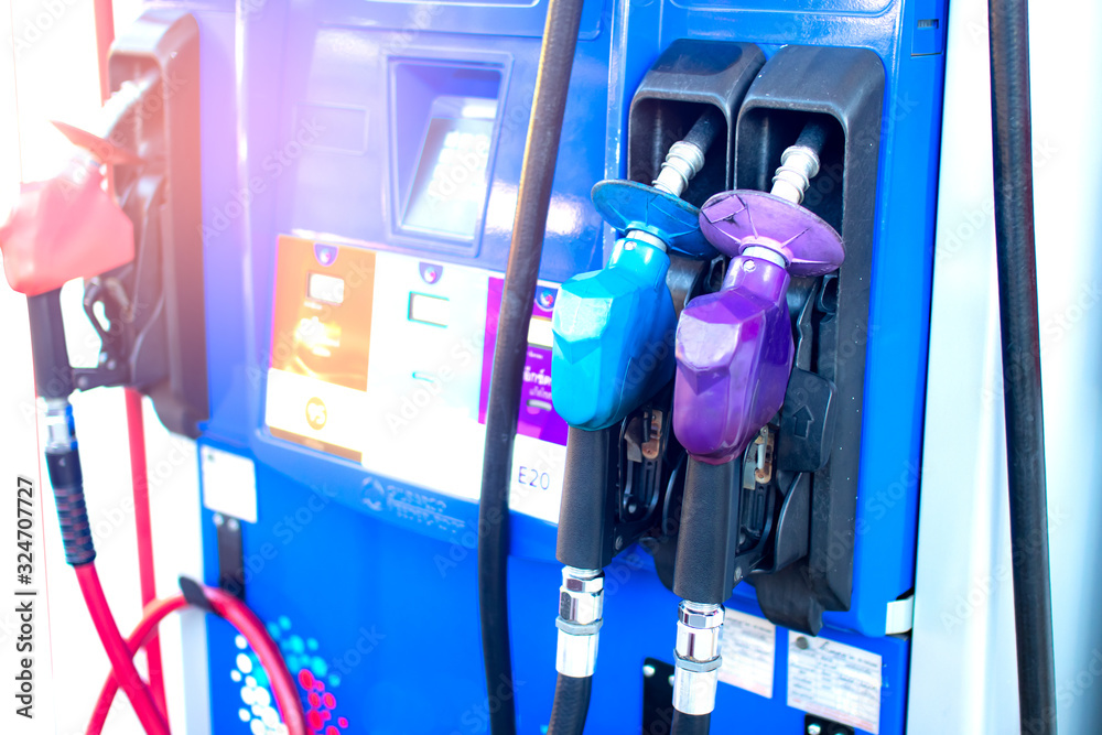 Oil nozzle or fuel injector and fuel dispenser, in pump station,consisting of petrol,diesel,ethanol and gasohol,energy and transportation business concept,alternative energy market