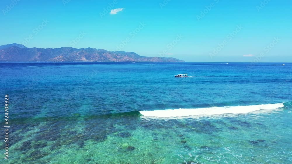 Boats sailing in the ocean, island hopping concept. Foamy waves rolling over the coral reef. Boats sailing in the ocean, island hopping concept. Foamy waves rolling over the coral reef.