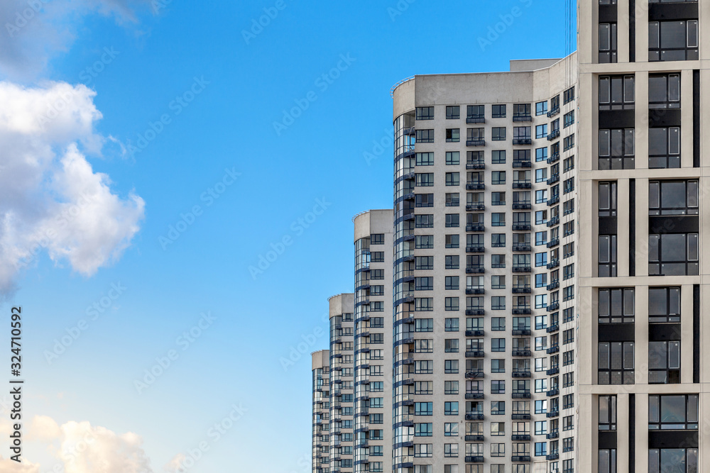 Modern high-rise buildings opposite a clear blue sky in perspective. The concept of urban development.