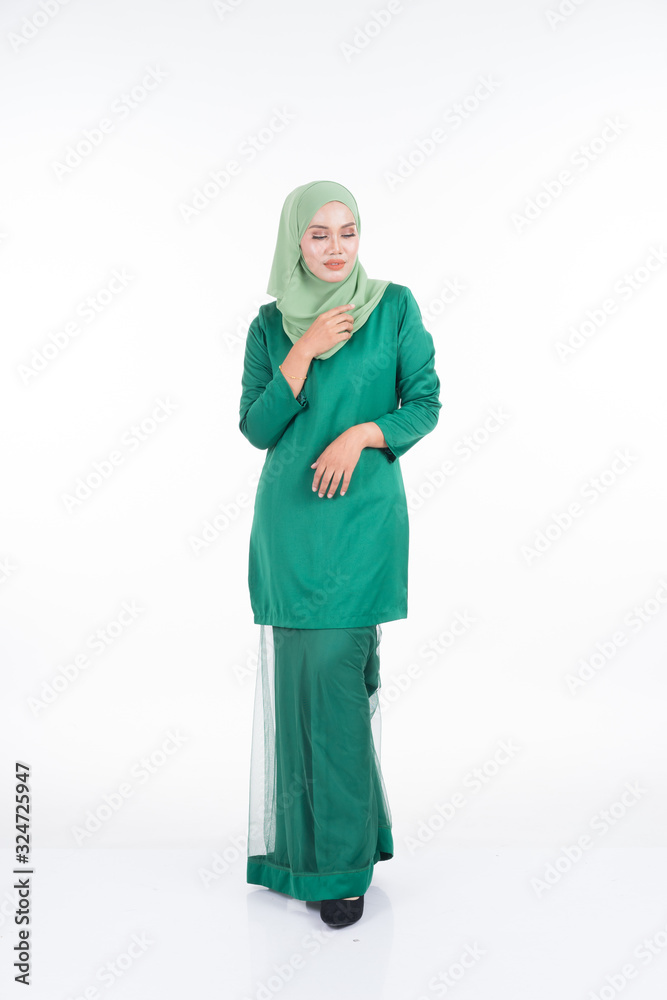 Beautiful female model in modern kurung and hijab, a modern lifestyle apparel for Muslim women isolated on white background. Beauty and hijab fashion concept. Full length portrait