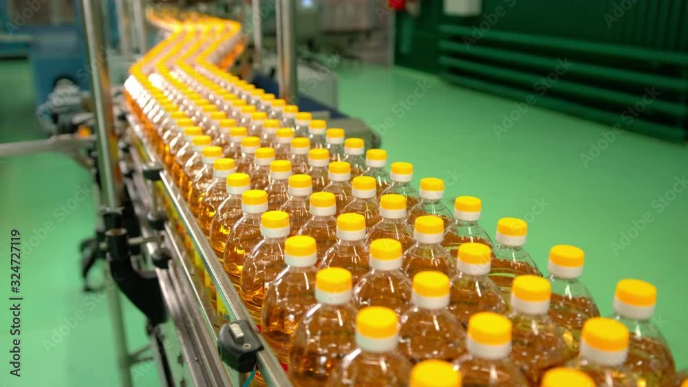 Sunflower oil in the bottle moving on production line. Sunflower oil in the bottle moving on production line.